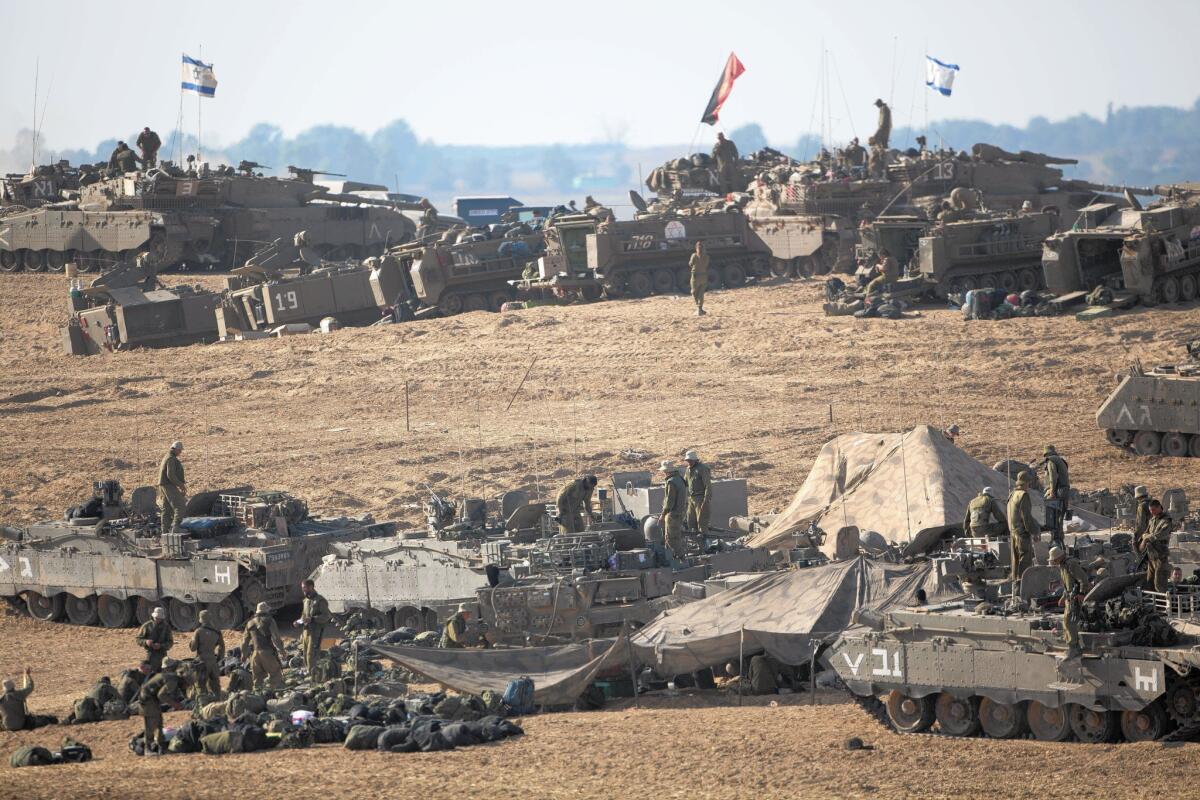 Israeli soldiers and tanks are deployed July 10 along the border with the Gaza Strip.