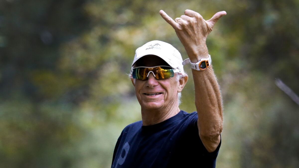 Mike Levine, stage 4 pancreatic cancer patient, flahes a "hang loose" hand signal during a training run in Rancho Santa Fe this week. He'll compete in October in the Ironman World Championship.