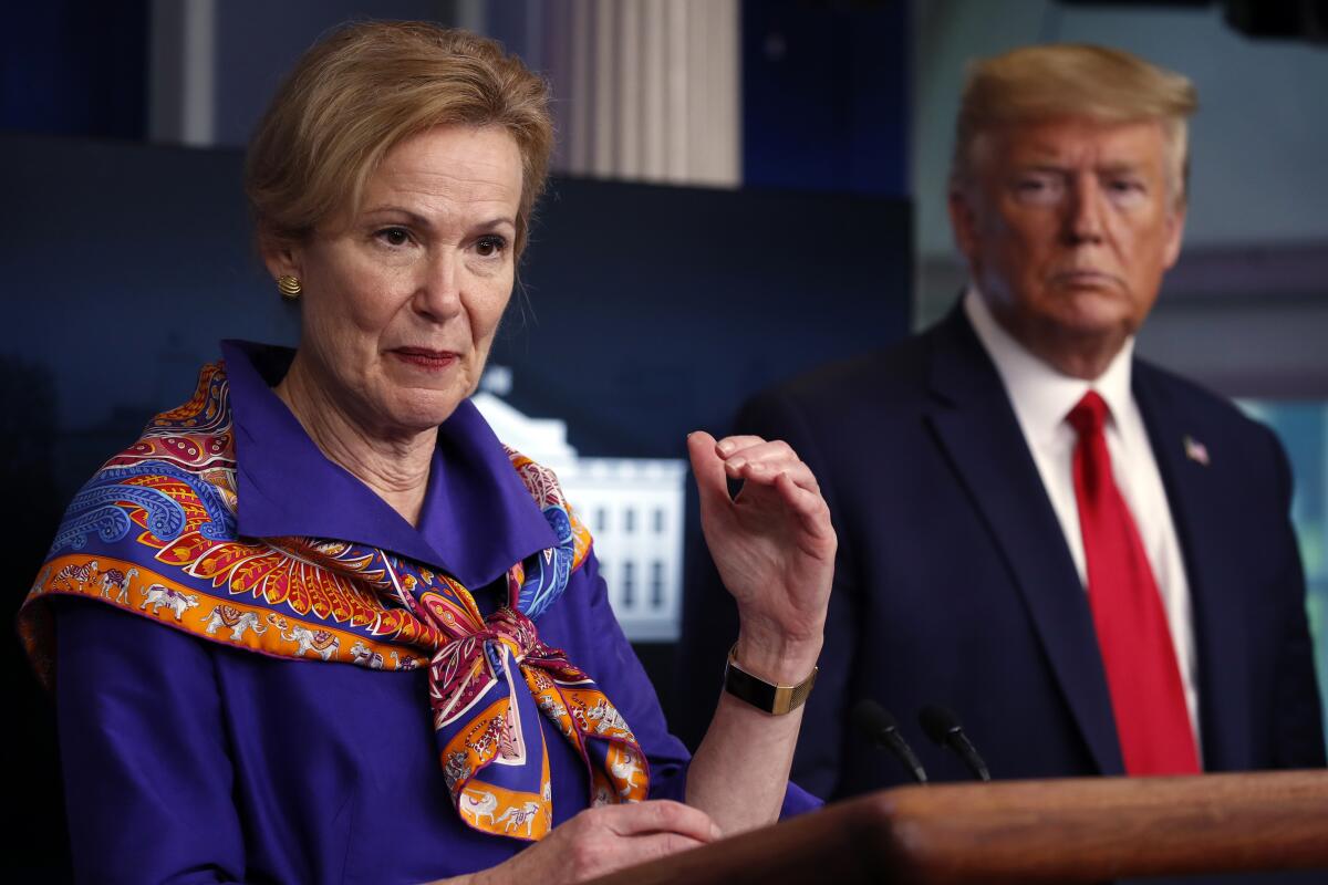 Trump listens as Deborah Birx, the White House coronavirus response coordinator, speaks at a news conference in 2020. 