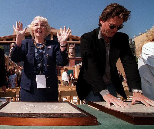 Virginia Davis and Kurt Russell make molds of their handprints as part of the 1998 75th anniversary celebration of Disney at the studios in Burbank.