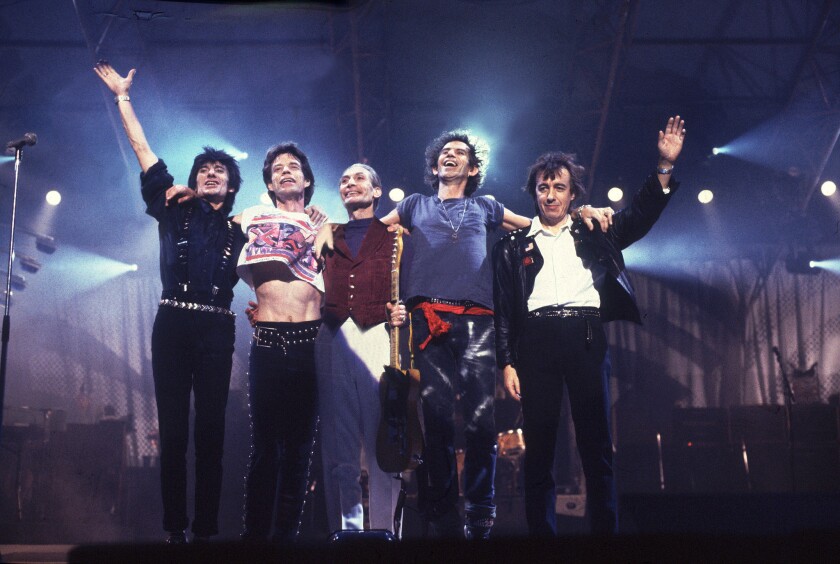 The Rolling Stones wave from the stage following a performance during their Steel Wheels tour. The band had a curious interaction with Donald Trump during the tour.