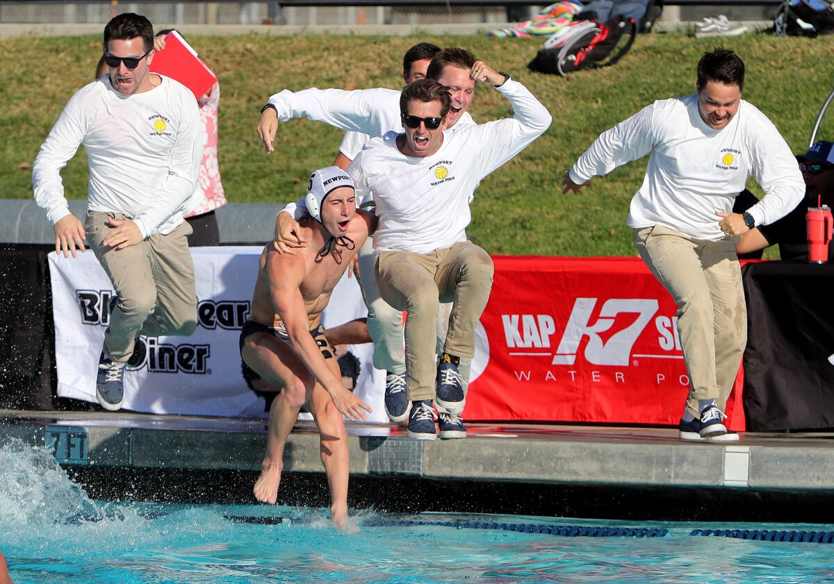 Newport Harbor head coach Ross Sinclair, center, and senior Gage Verdegaal, bottom, jump into the pool in celebration. 