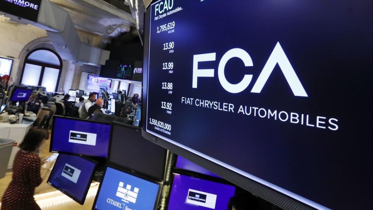The Fiat Chrysler Automobiles logo appears above a post on the floor of the New York Stock Exchange on Tuesday. Fiat Chrysler is proposing a merger with French carmaker Renault aimed at saving billions of dollars for both companies.