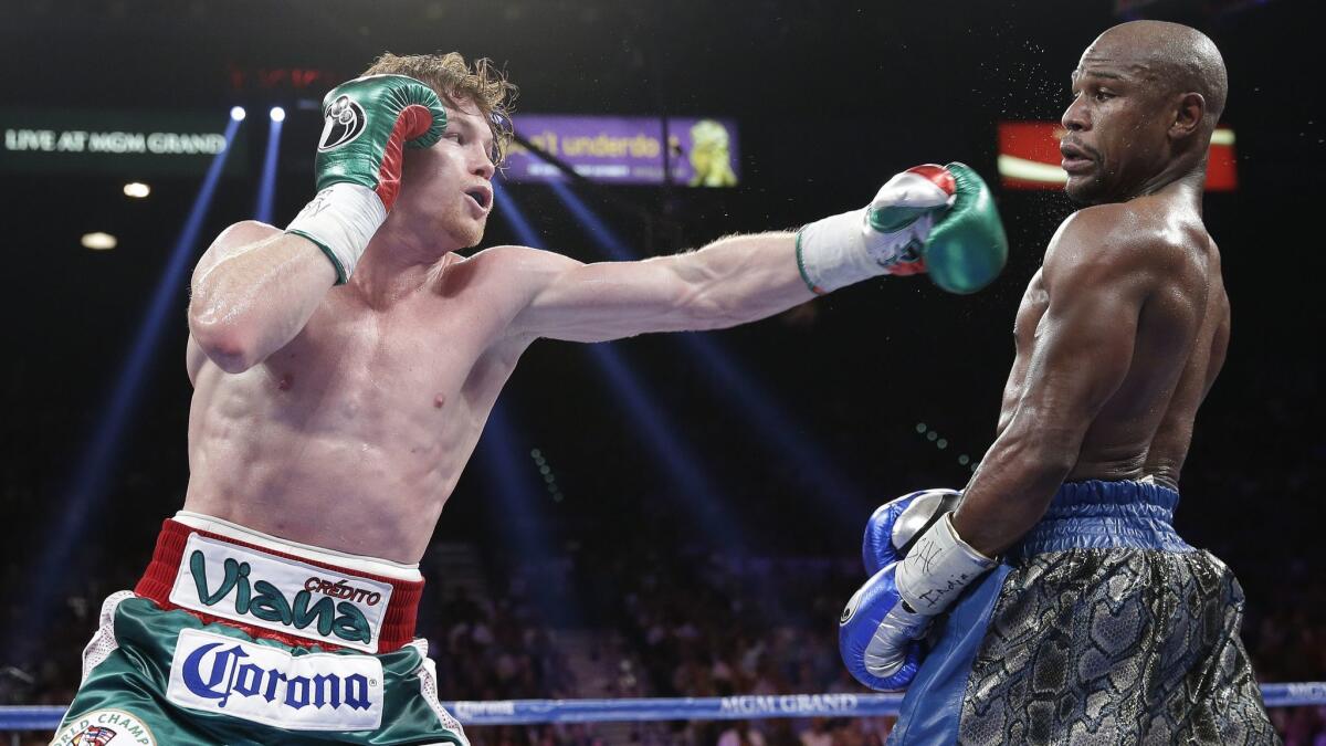 Canelo Alvarez throws a jab at Floyd Mayweather Jr. during their 2013 title fight in Las Vegas.