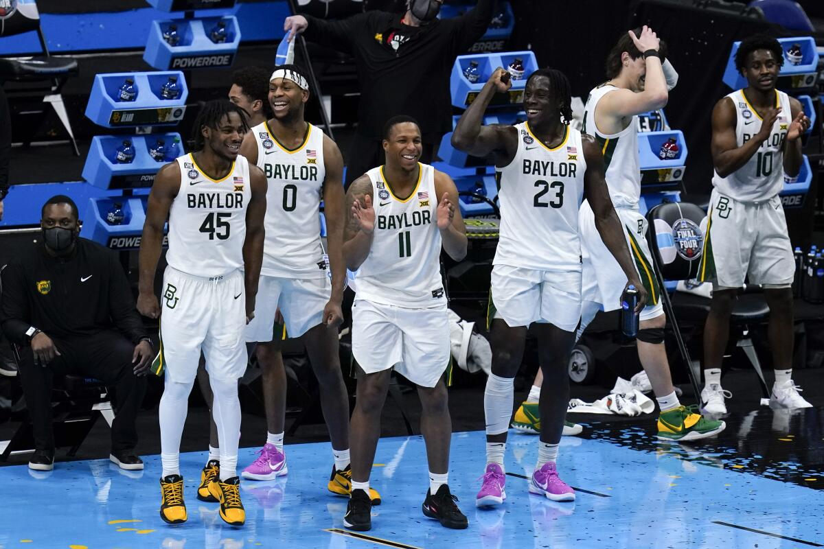Baylor players celebrate at the end of a men's Final Four NCAA college basketball tournament semifinal game.