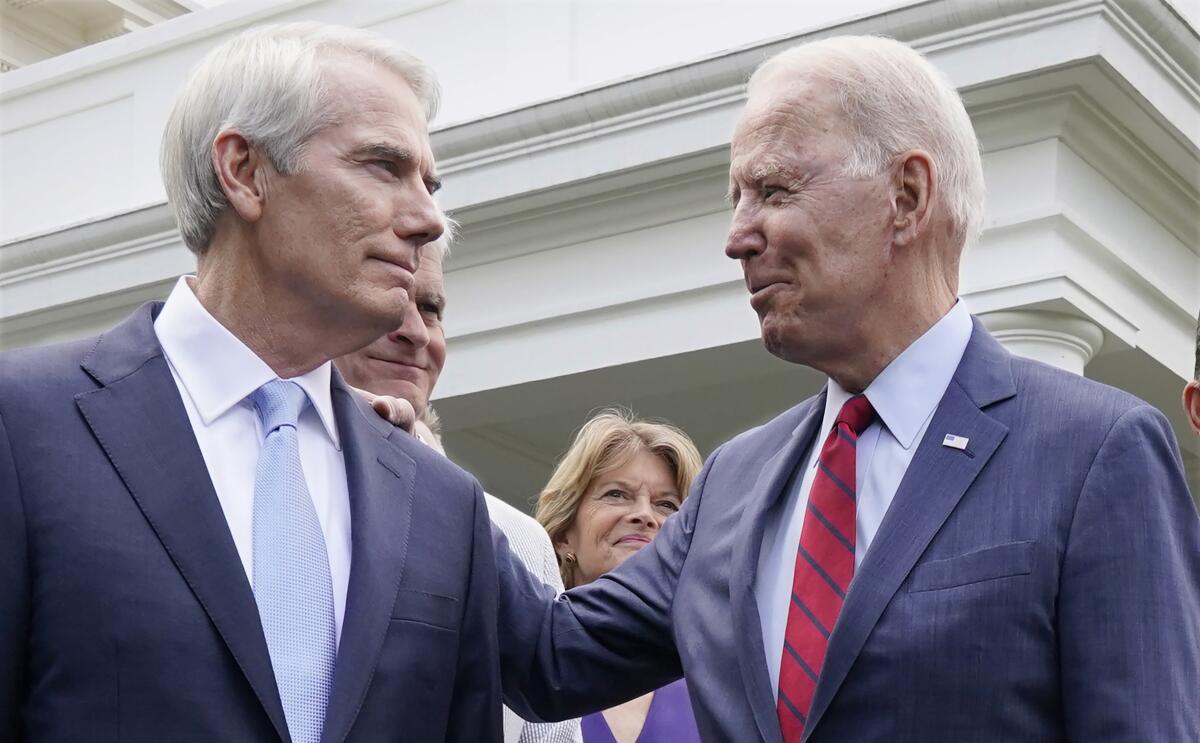 Rob Portman and other lawmakers stand outside the White House with Joe Biden.