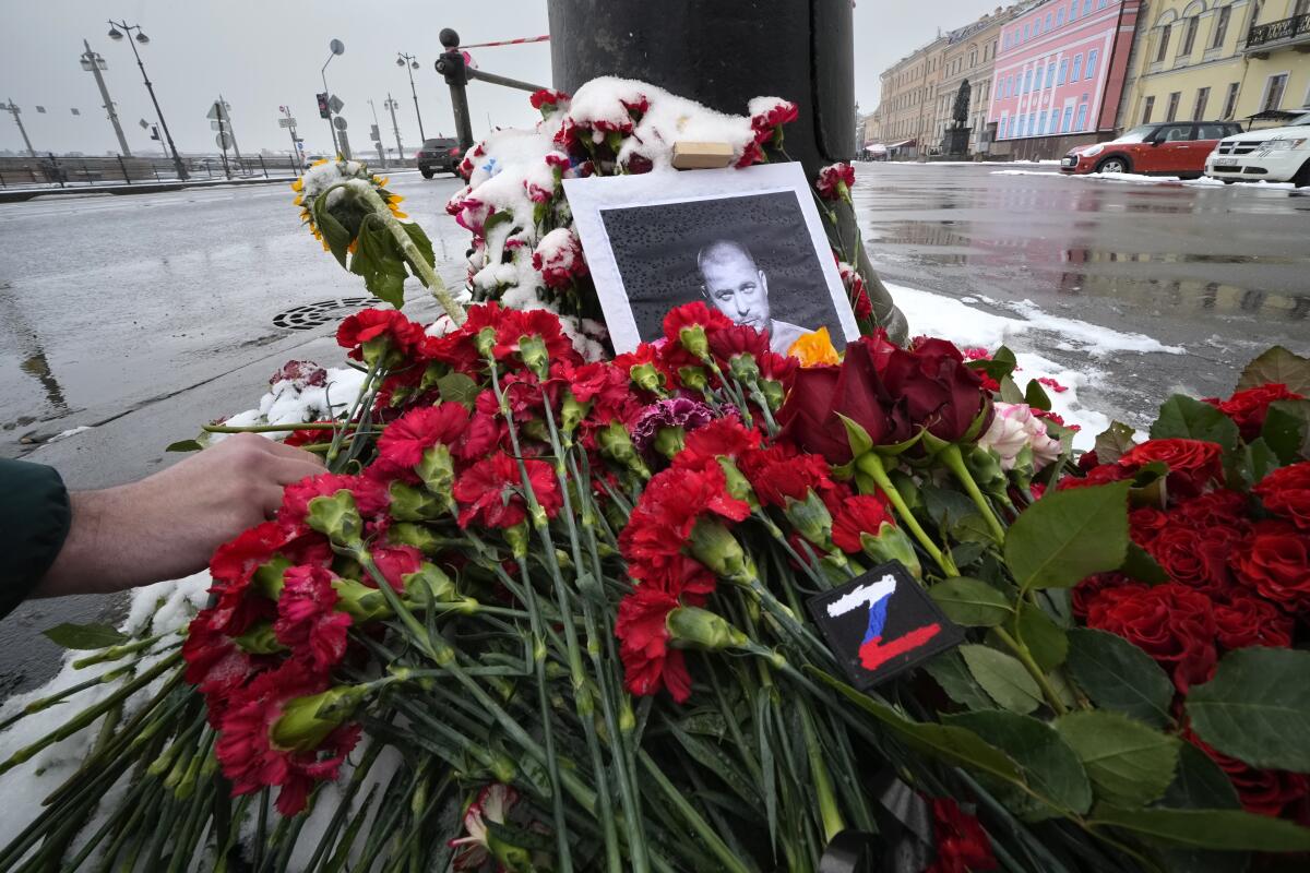 Flowers and a photo of slain Russian military blogger Vladlen Tatarsky