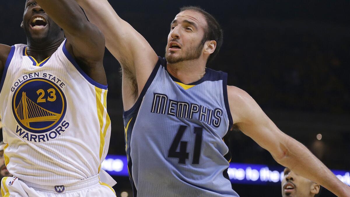 Memphis Grizzlies center Kosta Koufos, left, tries to grab a rebound in front of Golden State Warriors forward Draymond Green during a playoff game on May 5.