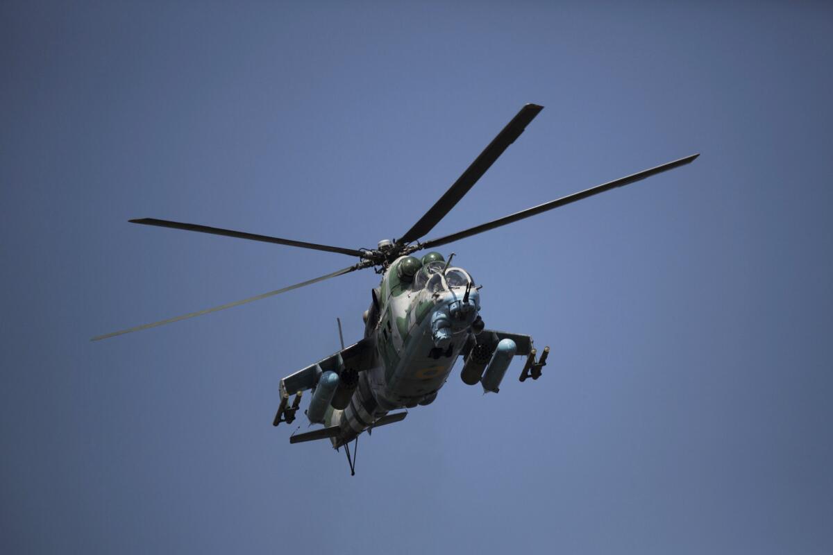 A Ukrainian helicopter flies over Slovyansk on Thursday. Pro-Russian separatists said they shot down a Ukrainian military helicopter that crashed at the local airport on Friday.