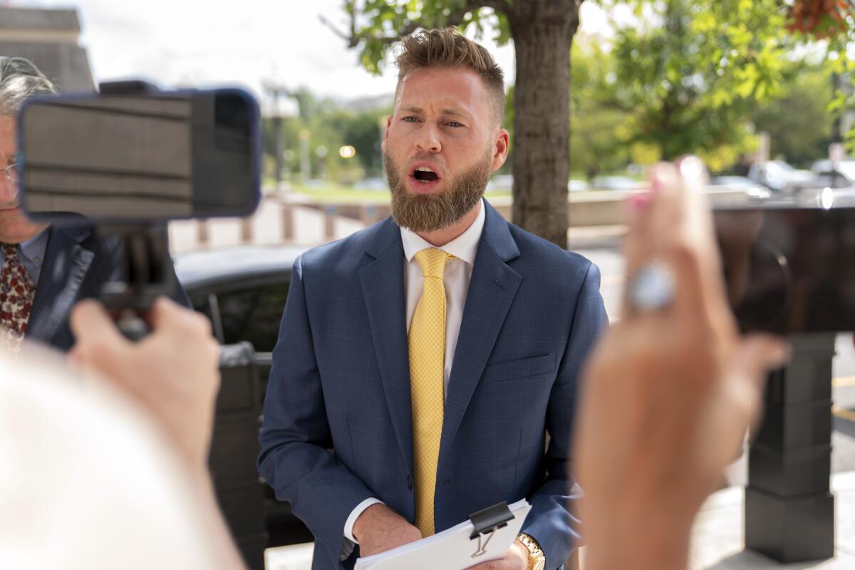 Infowars host Owen Shroyer, speaks to reporters outside the E. Barrett Prettyman U.S. Federal Courthouse, Tuesday, Sept. 12, 2023 in Washington. Shroyer was sentenced on Tuesday to two months behind bars for joining the mob's riot at the U.S. Capitol. Prosecutors said Shroyer helped create" Jan. 6, 2021, by spewing violent rhetoric and spreading baseless claims of election fraud to hundreds of thousands of viewers. (AP Photo/Jose Luis Magana)