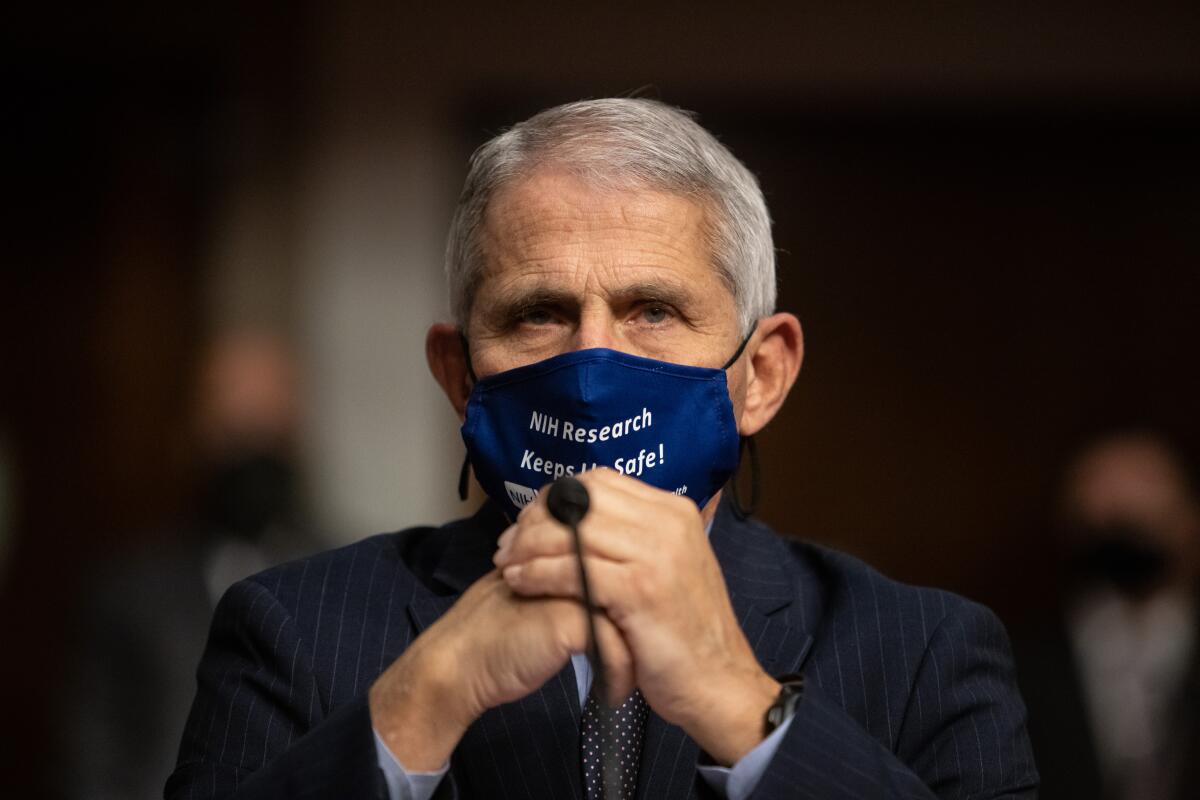 Anthony Fauci, wearing a face mask, looks on before testifying on Capitol Hill.