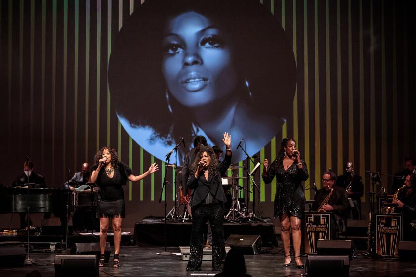Three Black women singers and a band perform a tribute to Diana Ross.