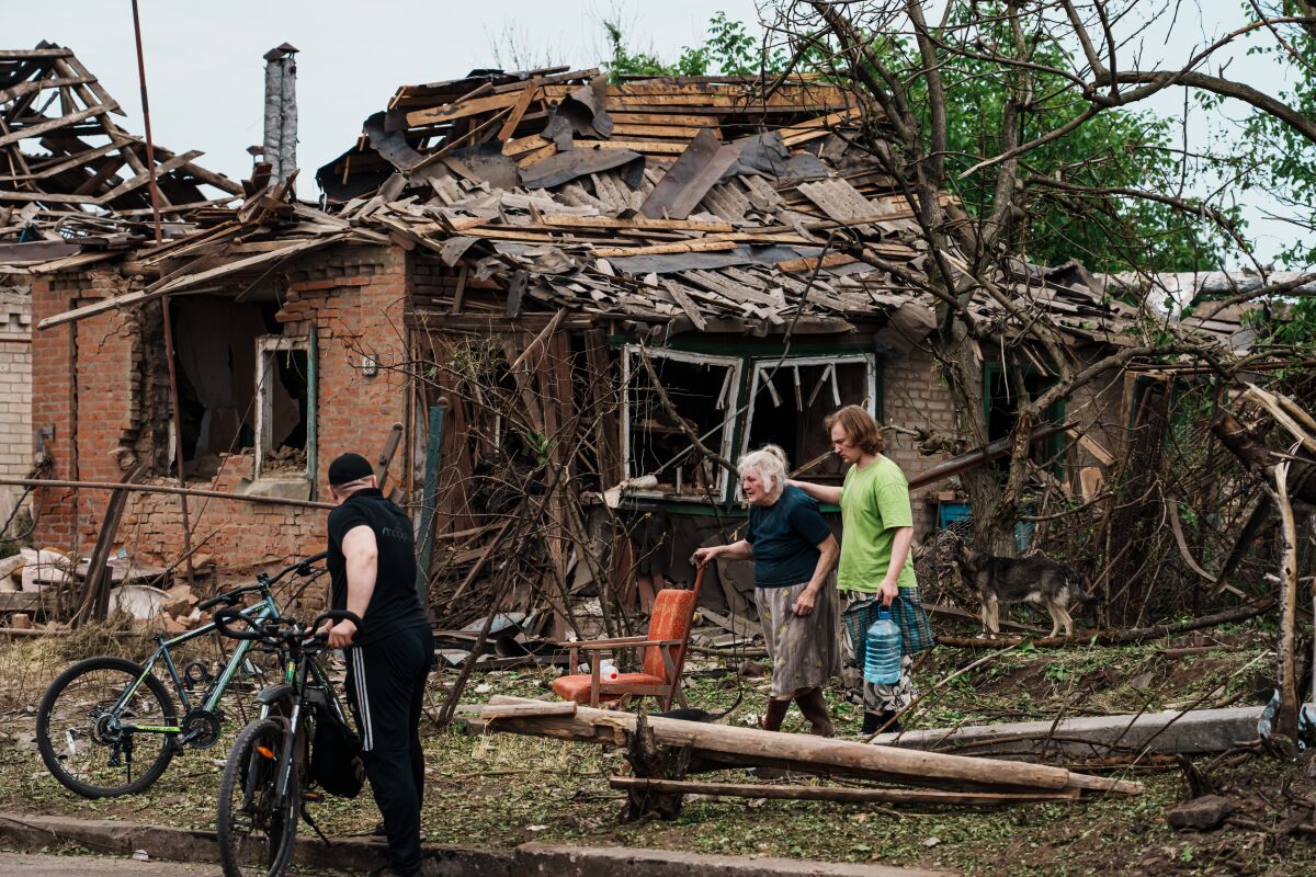 Residents who survived the bombardment in a residential neighborhood the night before, are evacuated, in Druzhkivka.