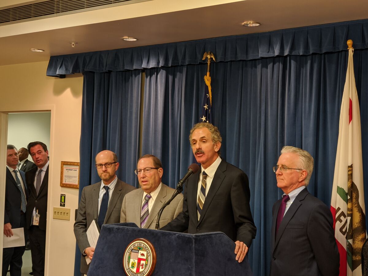 Los Angeles City Atty. Mike Feuer, center, announced on Thursday that his office is suing the FAA over the noise issues stemming from Hollywood Burbank Airport.
