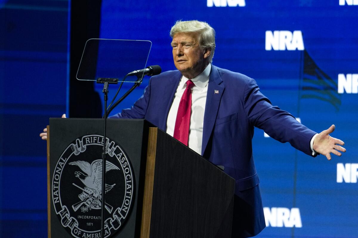 Former President Trump speaks at an NRA lectern.