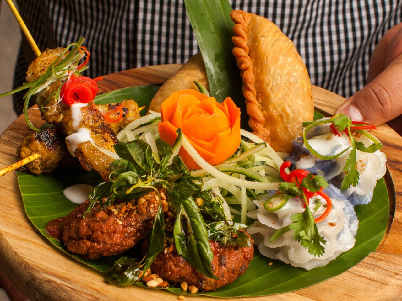 Jan ruam mit, Galangal's Thai platter, features Thai fish cake, Thai curry puff, Thai chicken satay, Chor mung flower dumplings.
