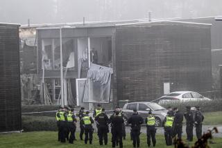 Police stand on the site of a powerful explosion that occurred early Thursday morning Sept. 28, 2023, in a housing area in Storvreta outside Uppsala, Sweden. A 25-year-old woman died in the blast. (Anders Wiklund/TT News Agency via AP)