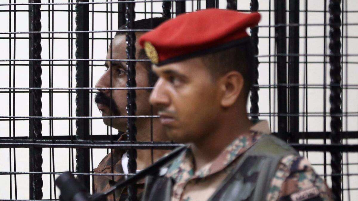 Maarek Abu Tayeh stands behind bars on July 17, 2017, in the Jordanian capital, Amman, during his trial for the killing of three American military trainers outside an army base last year.