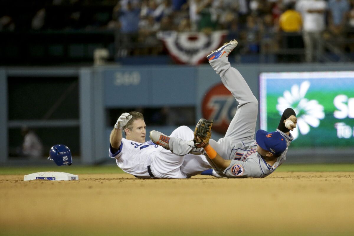 Mets shortstop Ruben Tejada, right, lands next to Dodgers baserunner Chase Utley, who broke up a double play with a hard takeout slide during the seventh inning in Game 2 of the NLDS.
