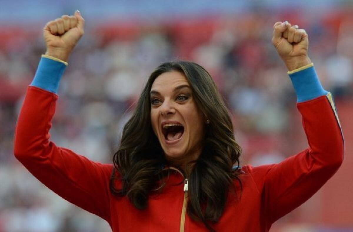 Russia's Yelena Isinbayeva smiles on the podium during the medal ceremony for the women's pole vault at the 2013 IAAF World Championships in Moscow on Thursday.