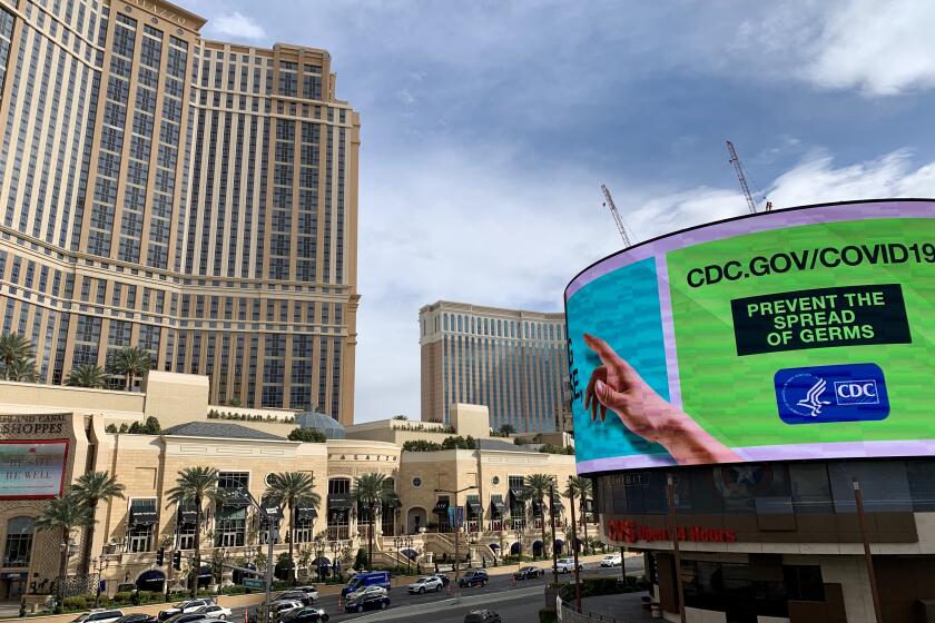 A view of the Palazzo and a CDC announcement on the Las Vegas Strip