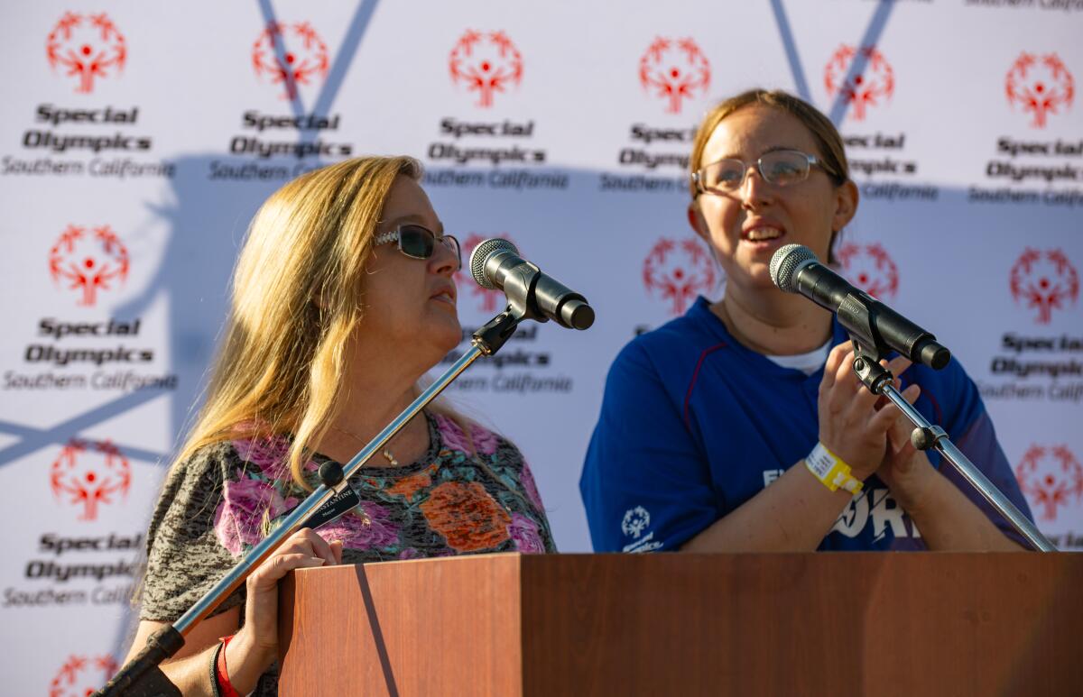 Fountain Valley Mayor Kim Constantine, left, addresses attendees of the Special Olympics Southern California Fall Games.