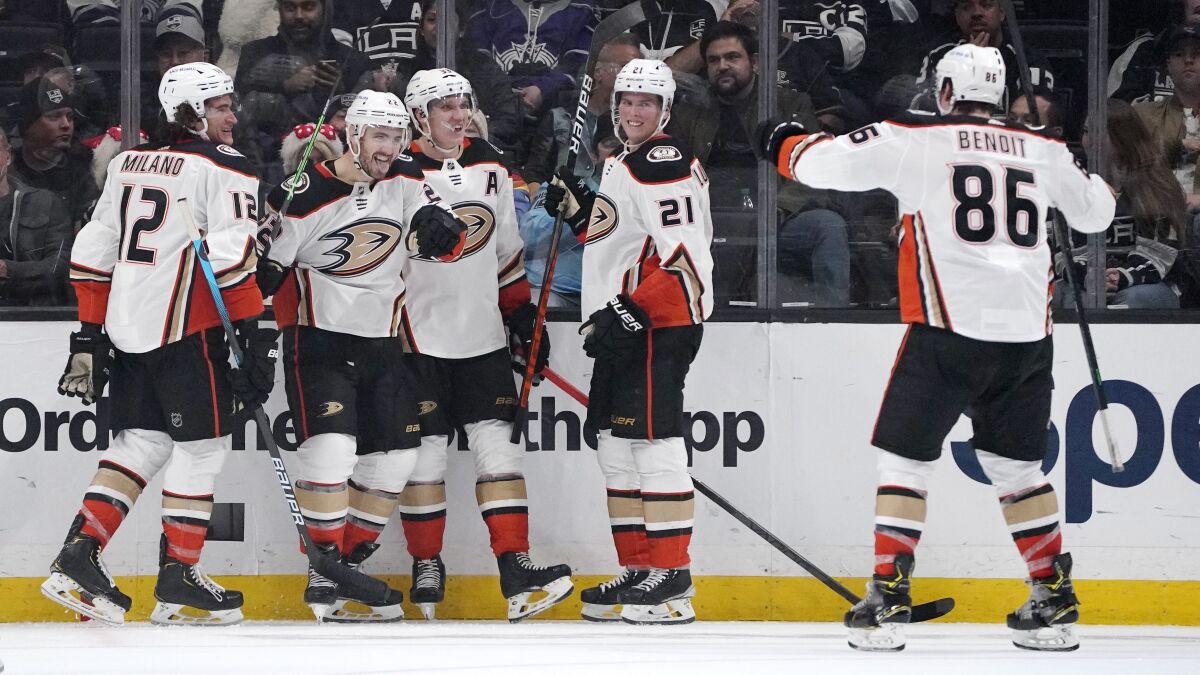 Anaheim Ducks defenseman Kevin Shattenkirk, second from left, celebrates his goal with teammates left wing Sonny Milano, left, right wing Jakob Silfverberg, center, center Isac Lundestrom, second from right, and defenseman Simon Benoit during the second period of an NHL hockey game against the Los Angeles Kings Tuesday, Nov. 30, 2021, in Los Angeles. (AP Photo/Mark J. Terrill)