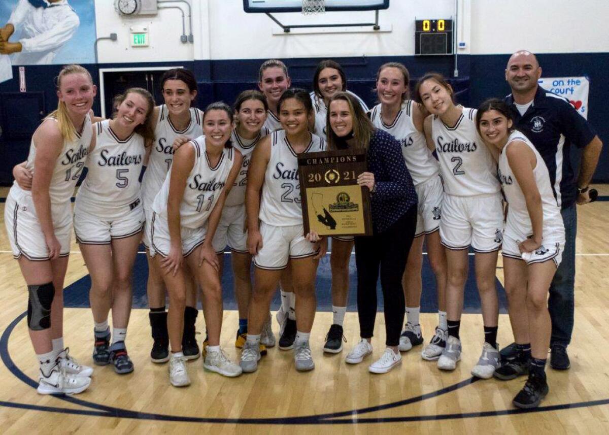 The Newport Harbor girls' basketball team poses with the championship trophy.