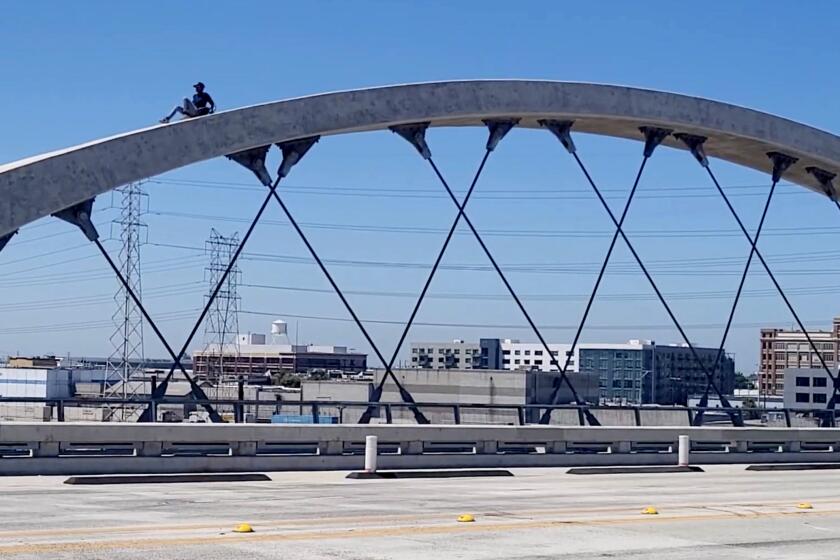 A woman in her mid 20s was seen climbing and dancing on top of one of the arches on the 6th Street Bridge Thursday morning.