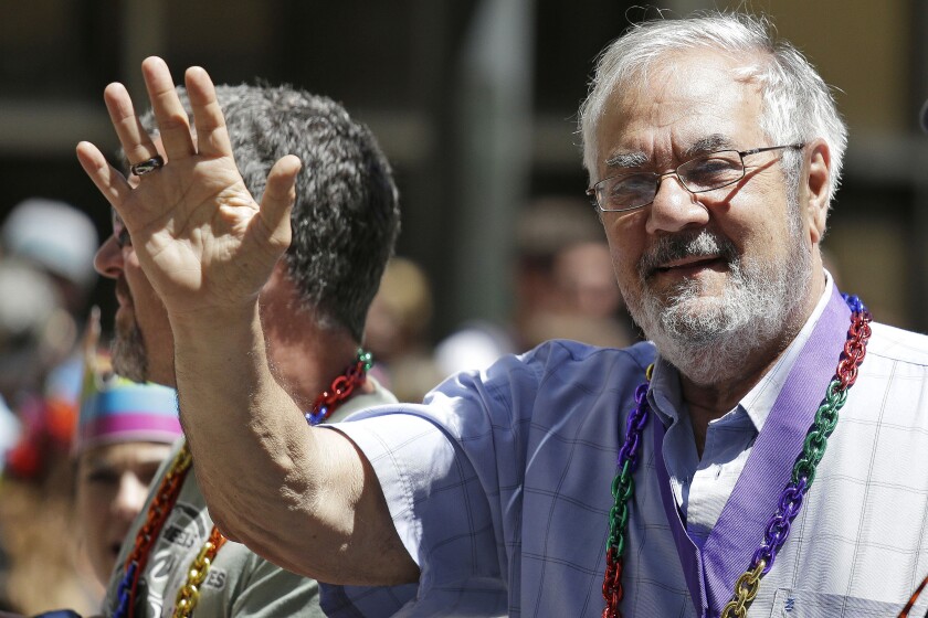 FILE - In this June 29, 2014, file photo, former Massachusetts congressman Barney Frank, right, waves while riding with his husband James Ready, left, during the 44th annual San Francisco Gay Pride parade in San Francisco. Frank and Ready filed a lawsuit Wednesday, Dec. 2, 2020, against a construction contractor who they said abandoned the building of their home in Maine in May after only completing part of the agreed upon work. (AP Photo/Eric Risberg, File)