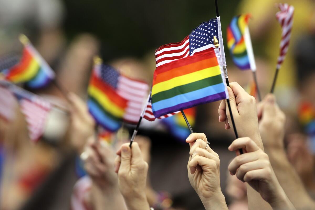 Flags are waved during the National LGBT 50th Anniversary Ceremony on July 4 in front of Independence Hall in Philadelphia. The event marks the 50th anniversary of a protest outside Independence Hall that would prove to be a milestone in the fight for gay rights.