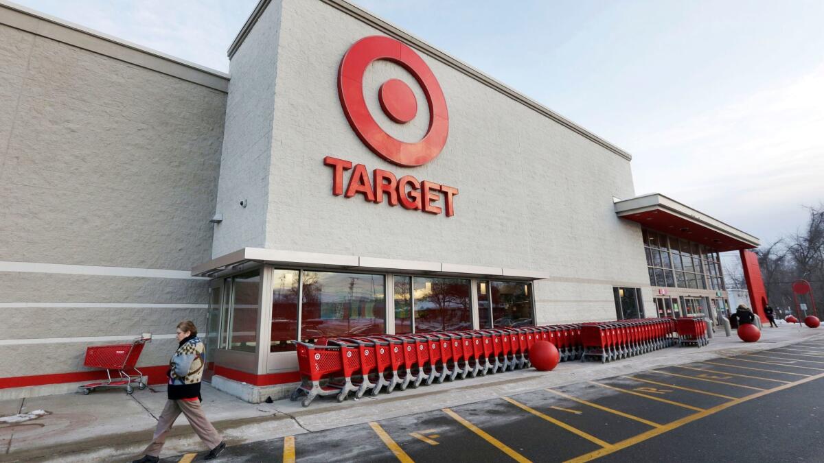A passer-by walks near an entrance to a Target store in Watertown, Mass., on Dec. 19, 2013.