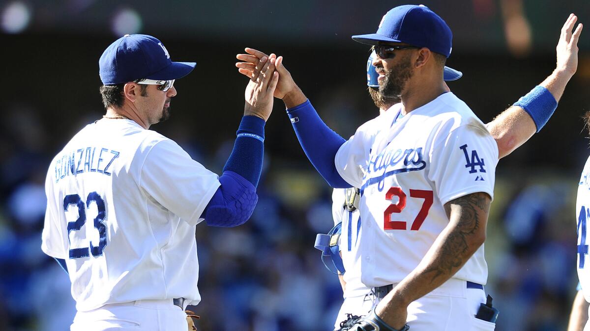 Dodgers teammates Adrian Gonzalez, left, and Matt Kemp celebrate a 7-2 win over the Arizona Diamondbacks on Sunday.