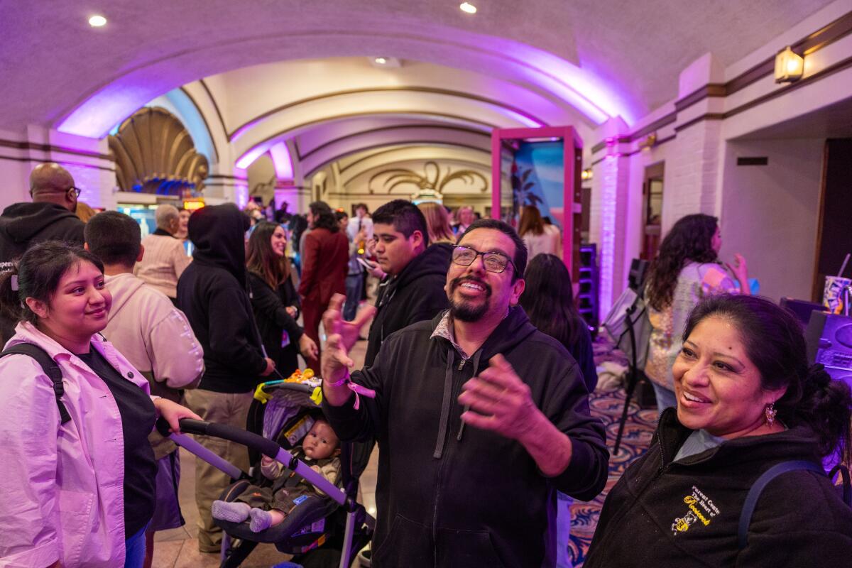 Jose Valencia, center, shown with his family, signs while attending "Barbie" with ASL.