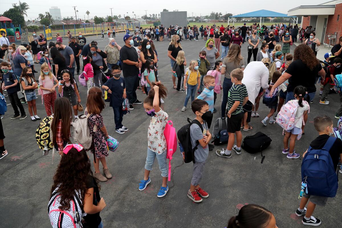 Students line up for class on their first day back to campus at Lake View Elementary School.