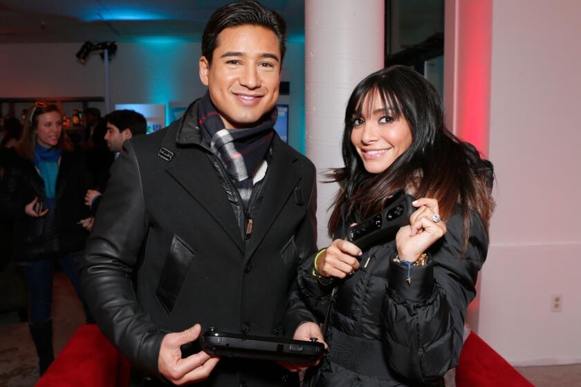 Mario Lopez, left, and Courtney Laine Mazza warm up at the Sundance Film Festival in January. They are expecting their second child.