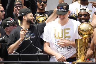 Denver Nuggets guard Jamal Murray (27) and Denver Nuggets center Nikola Jokic (15) during a rally and parade to mark the team's first NBA basketball championship on Thursday, June 15, 2023, in Denver. (AP Photo/David Zalubowski)