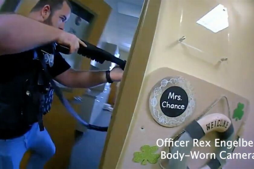 This image provided by Metropolitan Nashville Police Department shows bodycam footage of police responding to an active shooting at The Covenant School in Nashville, Tenn., on Monday, March 27, 2023. The former student who shot through the doors of the Christian elementary school and killed three children and three adults had drawn a detailed map of the school. (Metropolitan Nashville Police Department via AP)