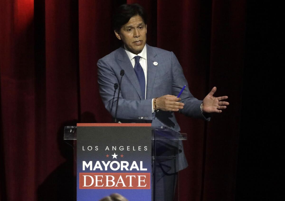 City Councilman Kevin de León at a lectern that says  "Los Angeles Mayoral Debate."