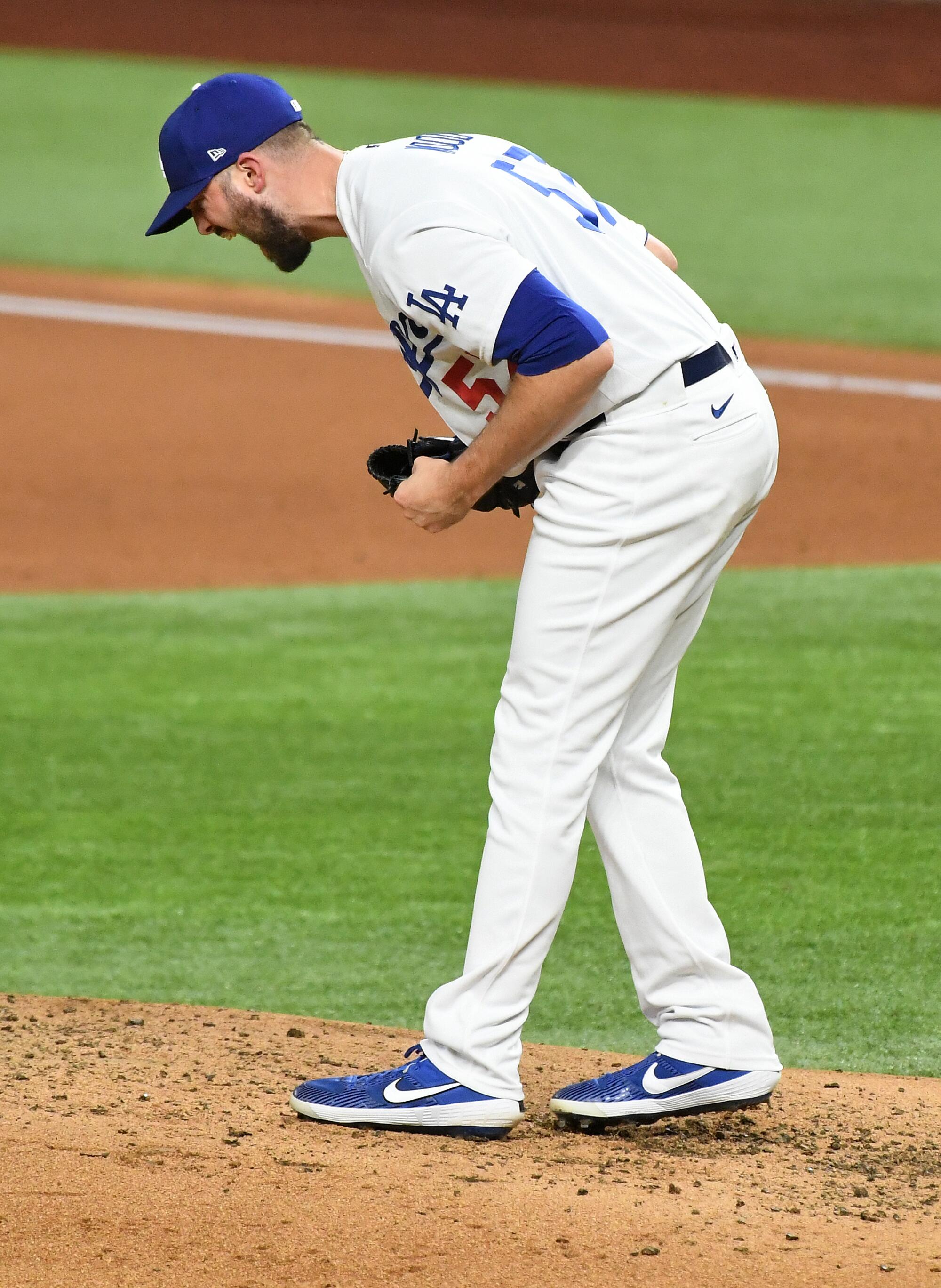 Dodgers pitcher Alex Wood bends and yells after a strikeout.