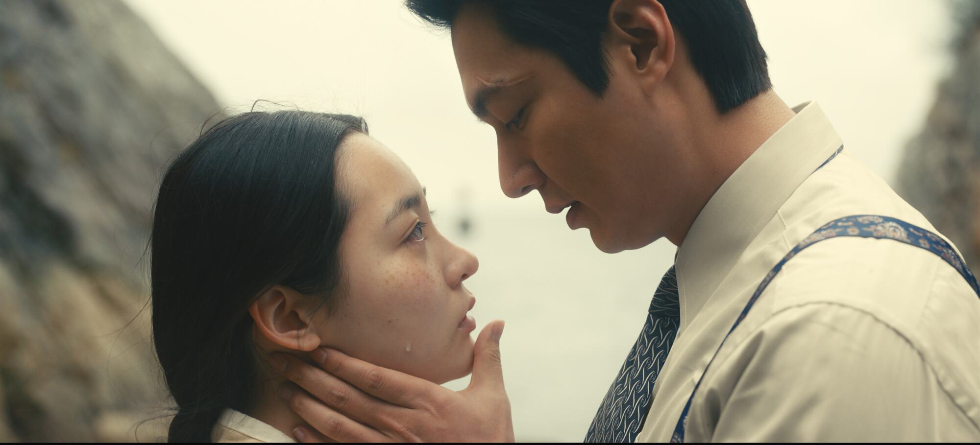 A man and woman look at each other tenderly in a scene from "Pachinko." 