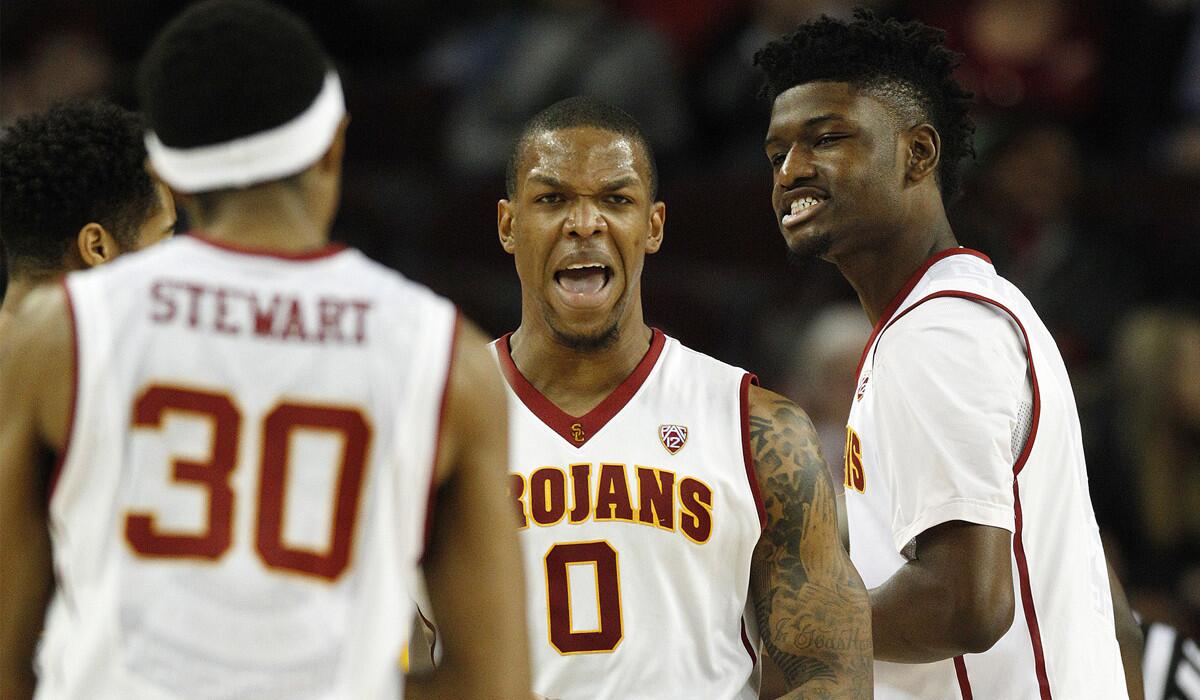 USC's Darion Clark (0) reacts with teammates Elijah Stewart (30) and Chimezie Metu after scoring a late basket against Arizona State on Jan. 7.