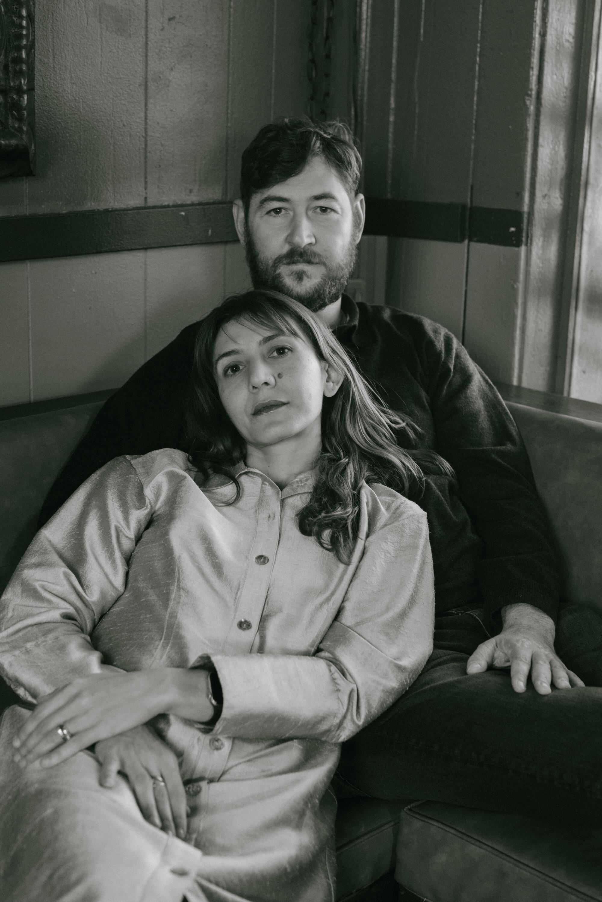 A woman embraced by a man in a black and white photo.