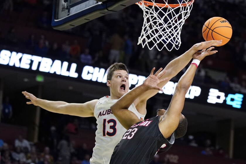 Auburn forward Walker Kessler blocks a shot by Jacksonville State guard Darian Adams during the first half of a college basketball game in the first round of the NCAA tournament on Friday, March 18, 2022, in Greenville, S.C. (AP Photo/Chris Carlson)