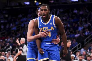 UCLA guard Jaime Jaquez Jr. holds back UCLA guard David Singleton as he reacts during the first half of an NCAA college basketball game against Kentucky in the CBS Sports Classic, Saturday, Dec. 17, 2022, in New York. (AP Photo/Julia Nikhinson)