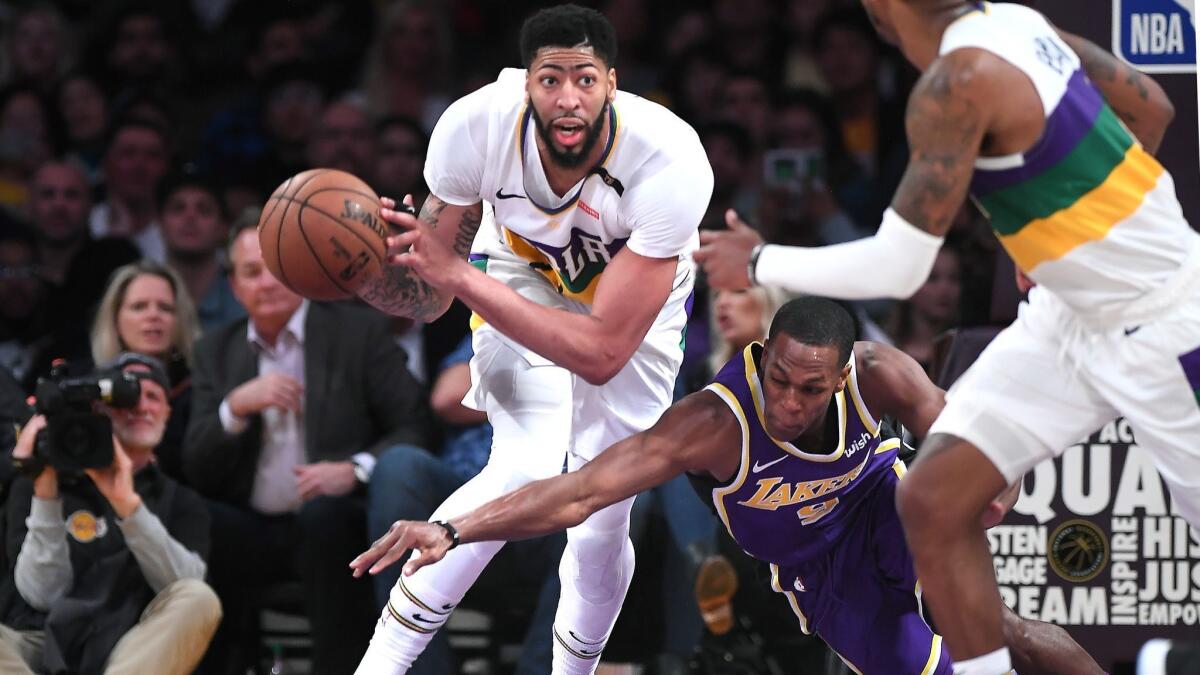 New Orleans Pelicans' Anthony Davis has the ball stripped by Lakers' Rajon Rondo in the third quarter on Wednesday at Staples Center.