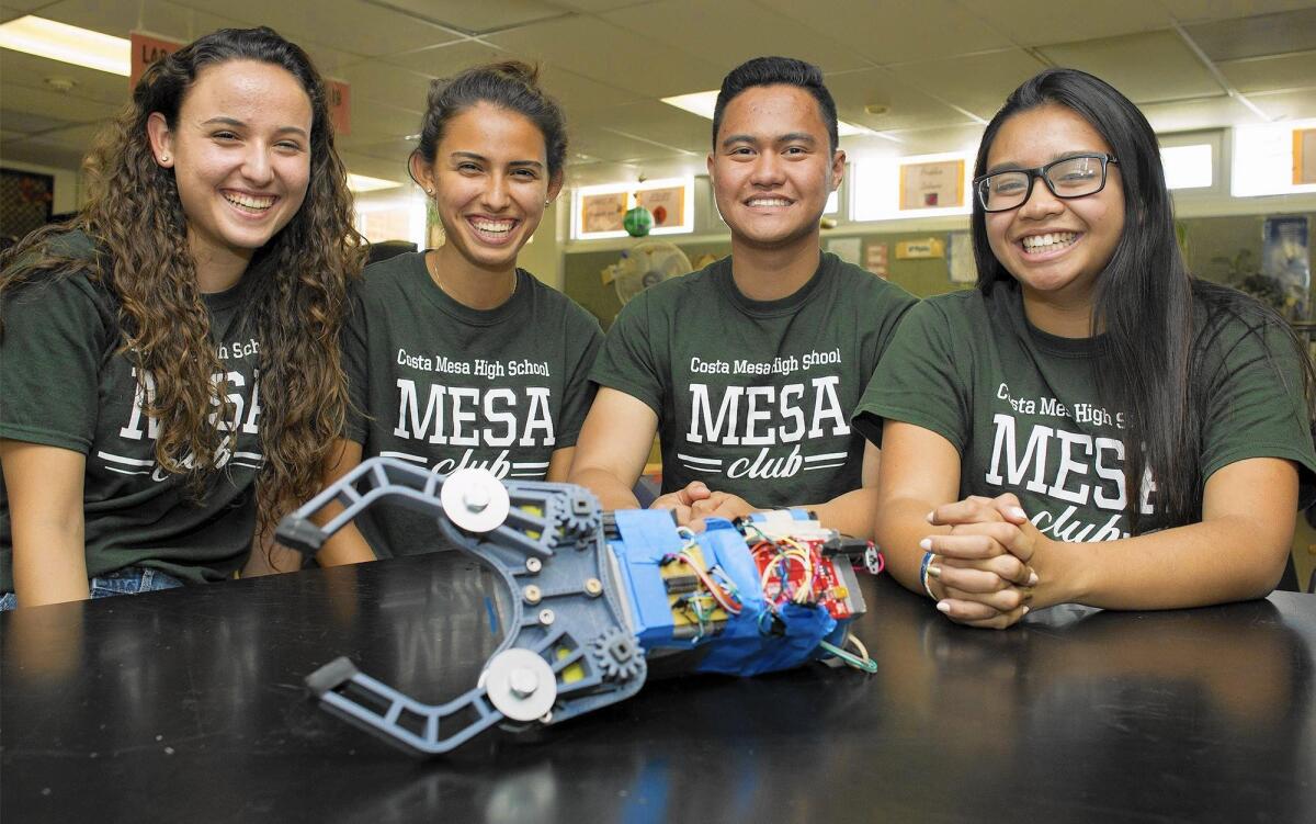 Costa Mesa High School students, from left, sisters Sarah and Sylvia Catania, Keiser Ruiz and Nancy Le show their robotic prosthetic arm, which the team will present this month at the MESA USA National Engineering Design Competition.
