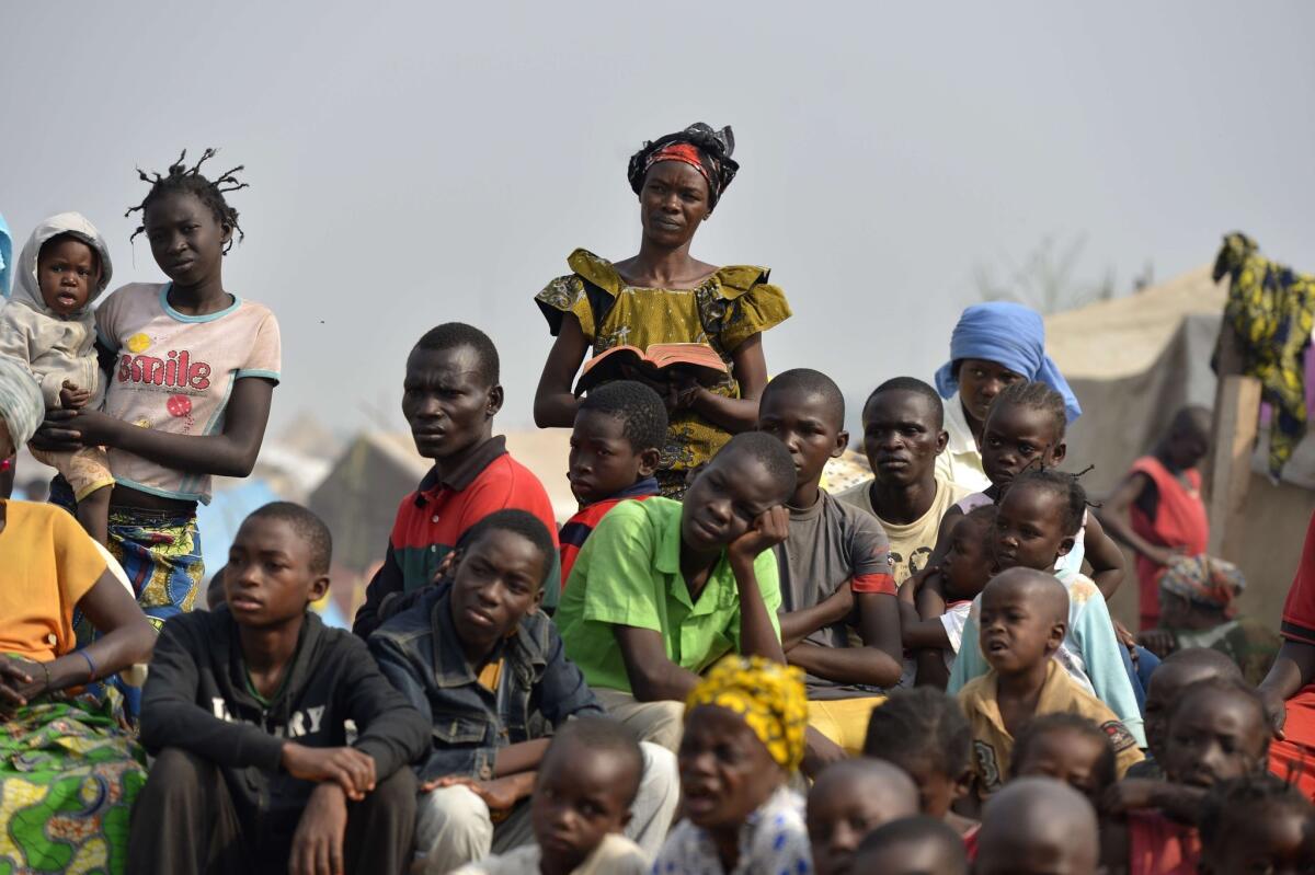 People attend mass at a camp for internally displaced persons close to the airport in Bangui. More than 1,000 people are believed to have been killed in three weeks of sectarian violence in Bangui alone.
