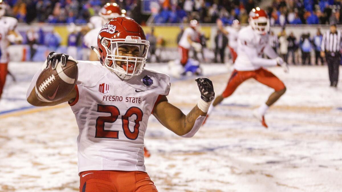 Fresno State running back Ronnie Rivers celebrates the game-winning touchdown against Boise State in overtime in a game for the Mountain West championship.