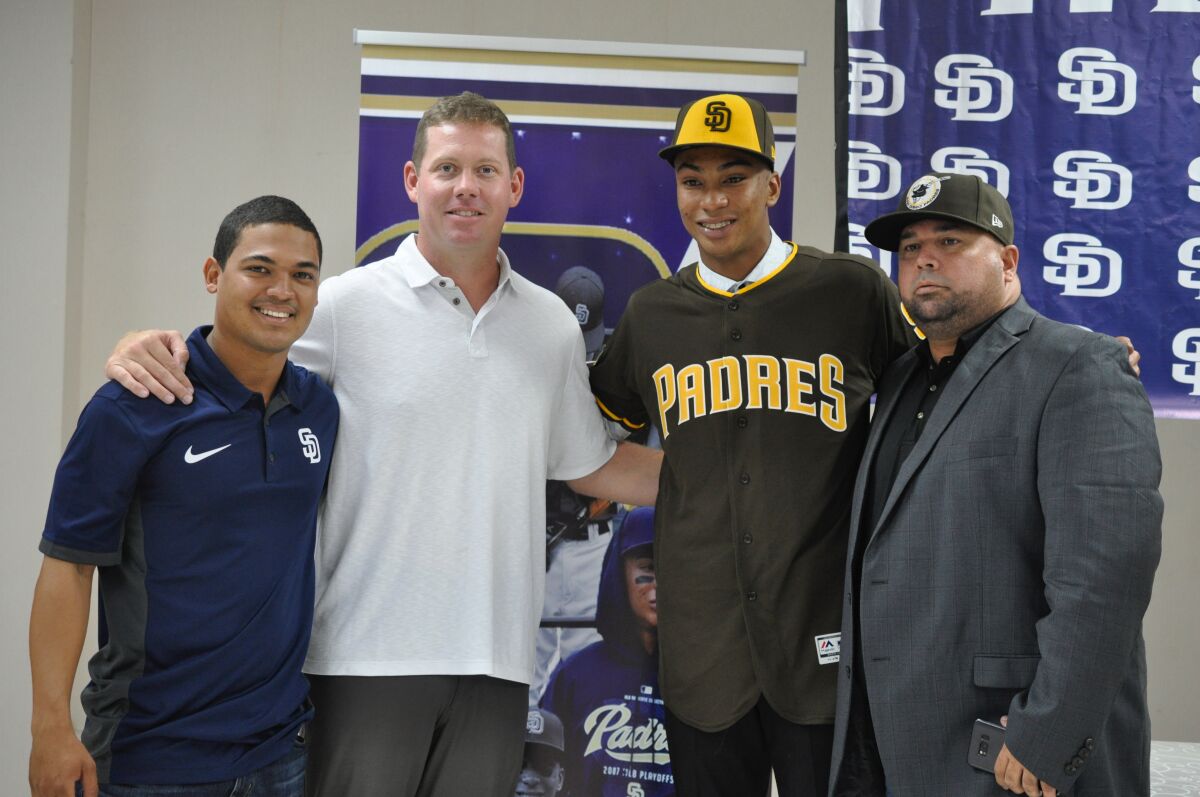 Shortstop Reginald Preciado of Panama center, signed with the Padres on July 2, 2019. He is pictured with, from left to right, Dominican coordinator Alvin Duran, international scouting director Chris Kemp and Panama area scout Ricardo Montenegro.